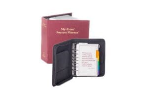 Black organizer with spiral planner and red box