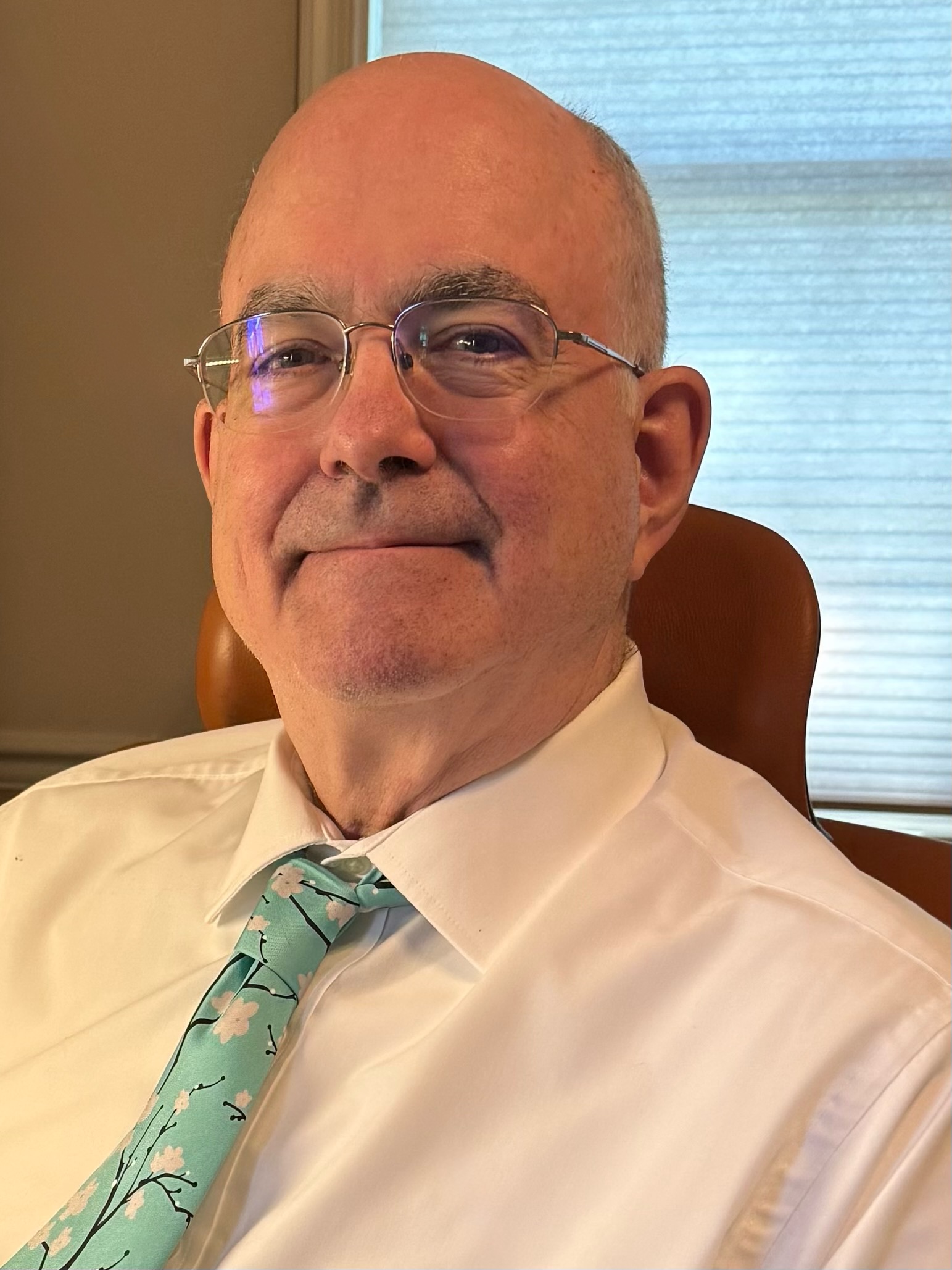 Man in white shirt and teal tie.