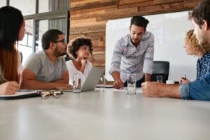 Team discussing project around conference table